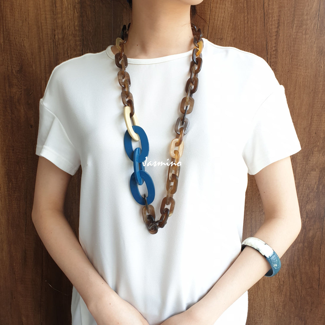 A model is wearing Jasmino unique handmade Vintage chain necklace featured blue and brown in natural buffalo horn for women