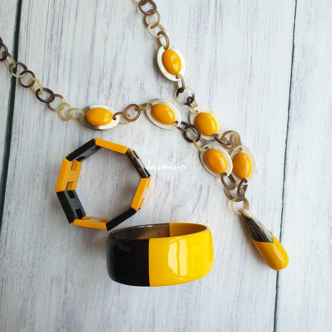 A set of unique handmade Vintage egg-shaped chain necklace and bangle bracelet features black and yellow in natural buffalo horn for women