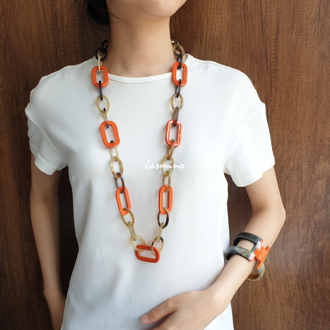 A model is wearing Jasmino unique handmade rectangle chain link necklace featured brown and orange in natural buffalo horn for women for Thanksgiving's gifts