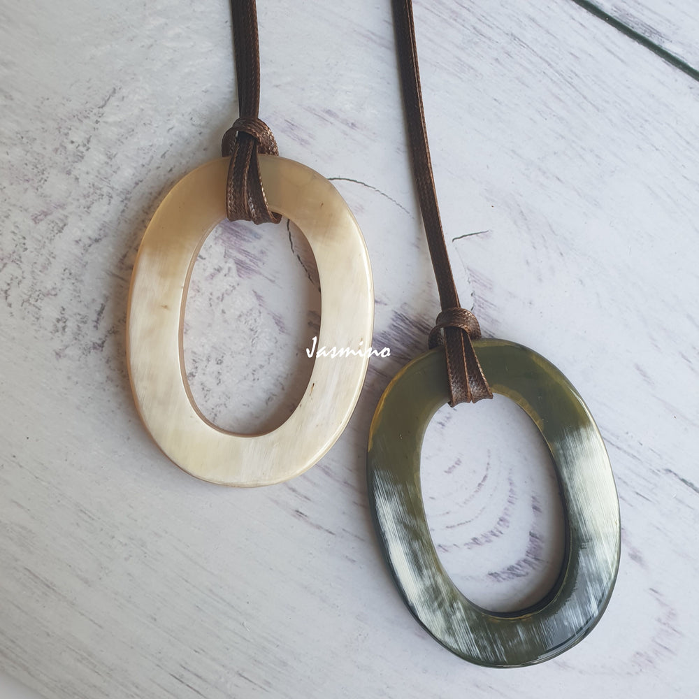 
                  
                    Two unique handmade Vintage large oval pendants are made of natural buffalo horn for women's gifts
                  
                