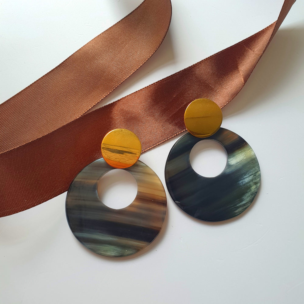 
                  
                    Grey full-moon circle drop earrings are handmade with natural buffalo horn material on a white background
                  
                