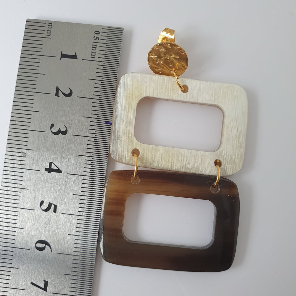 
                  
                    Double rectangle drop earrings are designed by brown and white color with natural buffalo horn that are 6 cm on a white background
                  
                