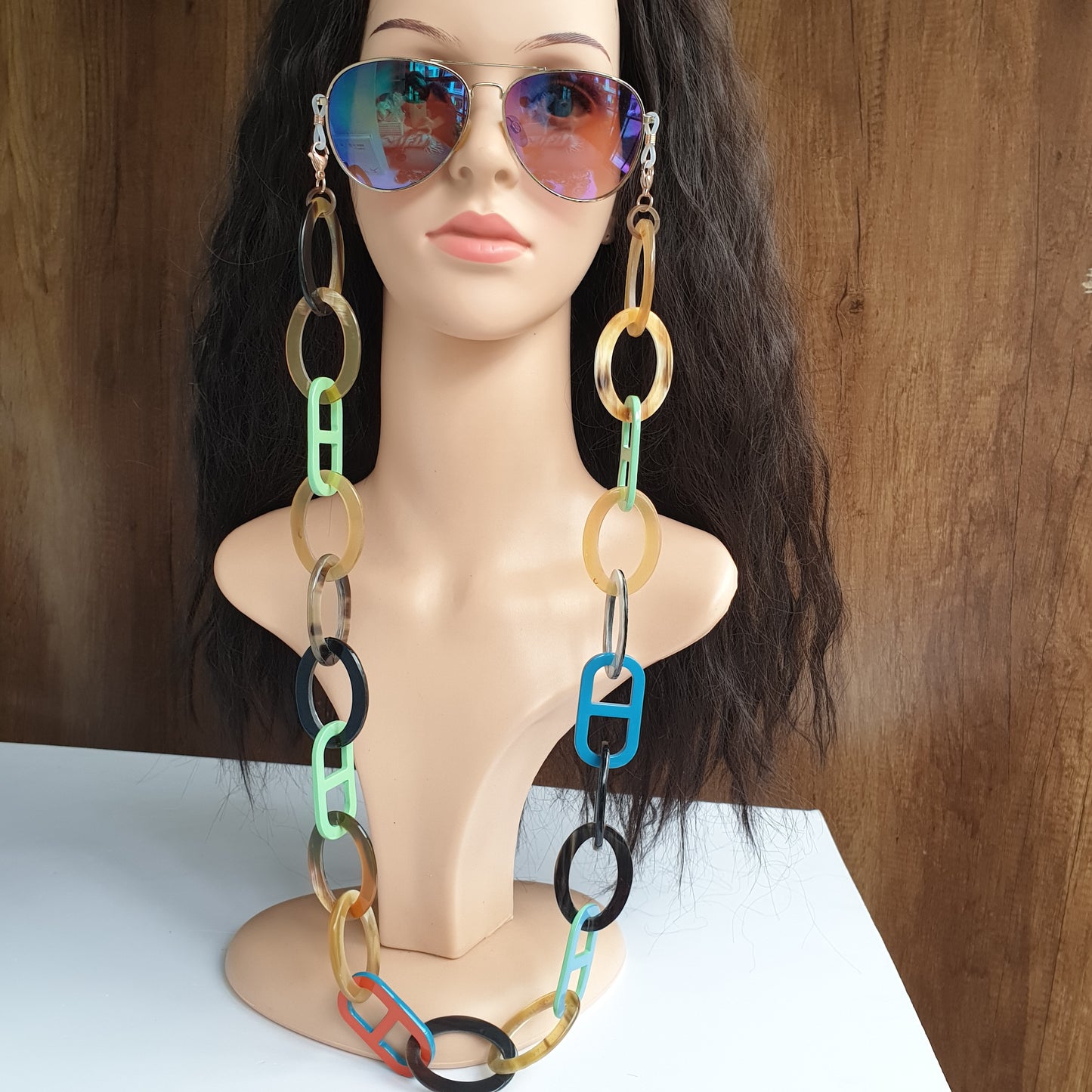Jasmino unique handmade Vintage glasses chains feature bright colors in natural buffalo horn for women that are hang on a mannequin