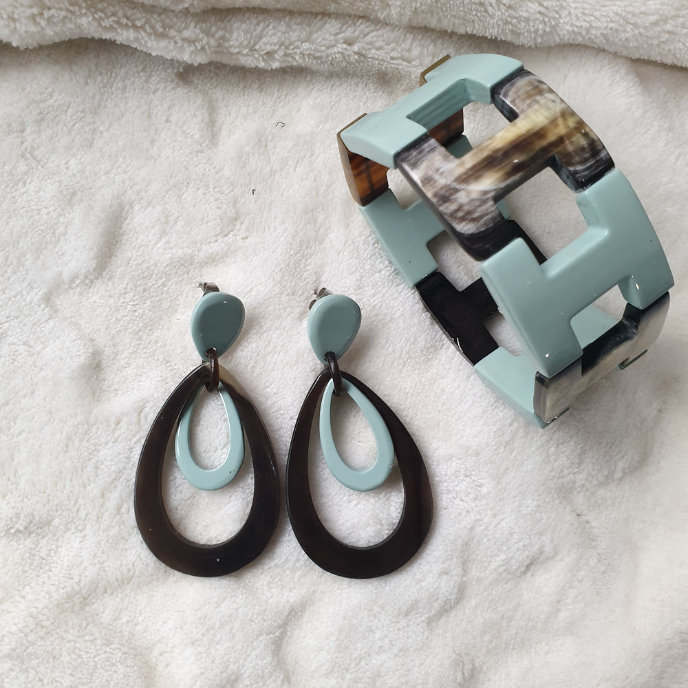 
                  
                    handmade double oval earrings and bangle bracelet feature greyish blue and black in natural buffalo horn for Spring 2023
                  
                