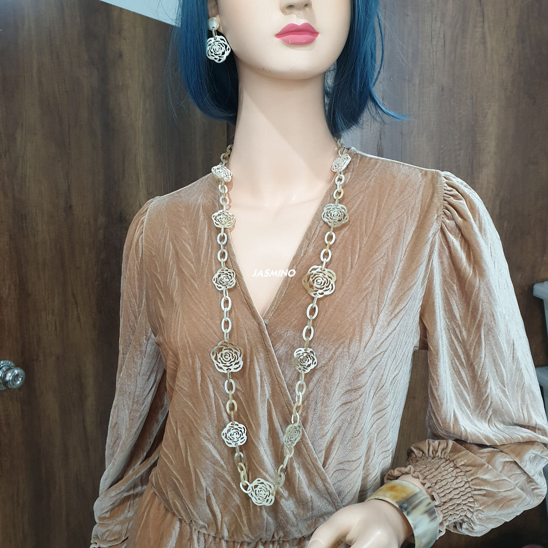 Minimalist white floral drop earrings and chain link necklace on mannequin