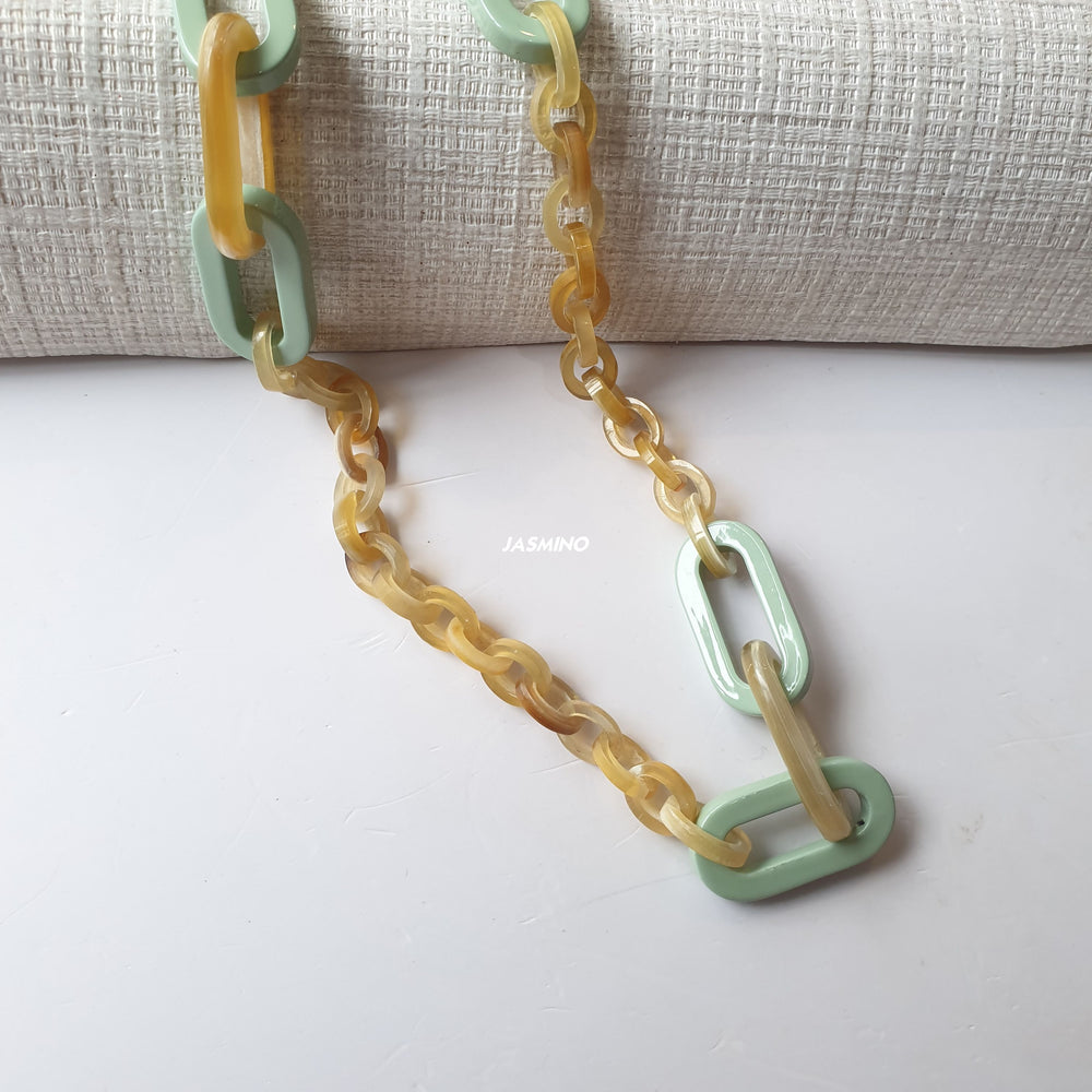 
                  
                    handmade rectangular chain link necklace features pale yellow and cadet blue in natural buffalo horn for Spring 2023
                  
                
