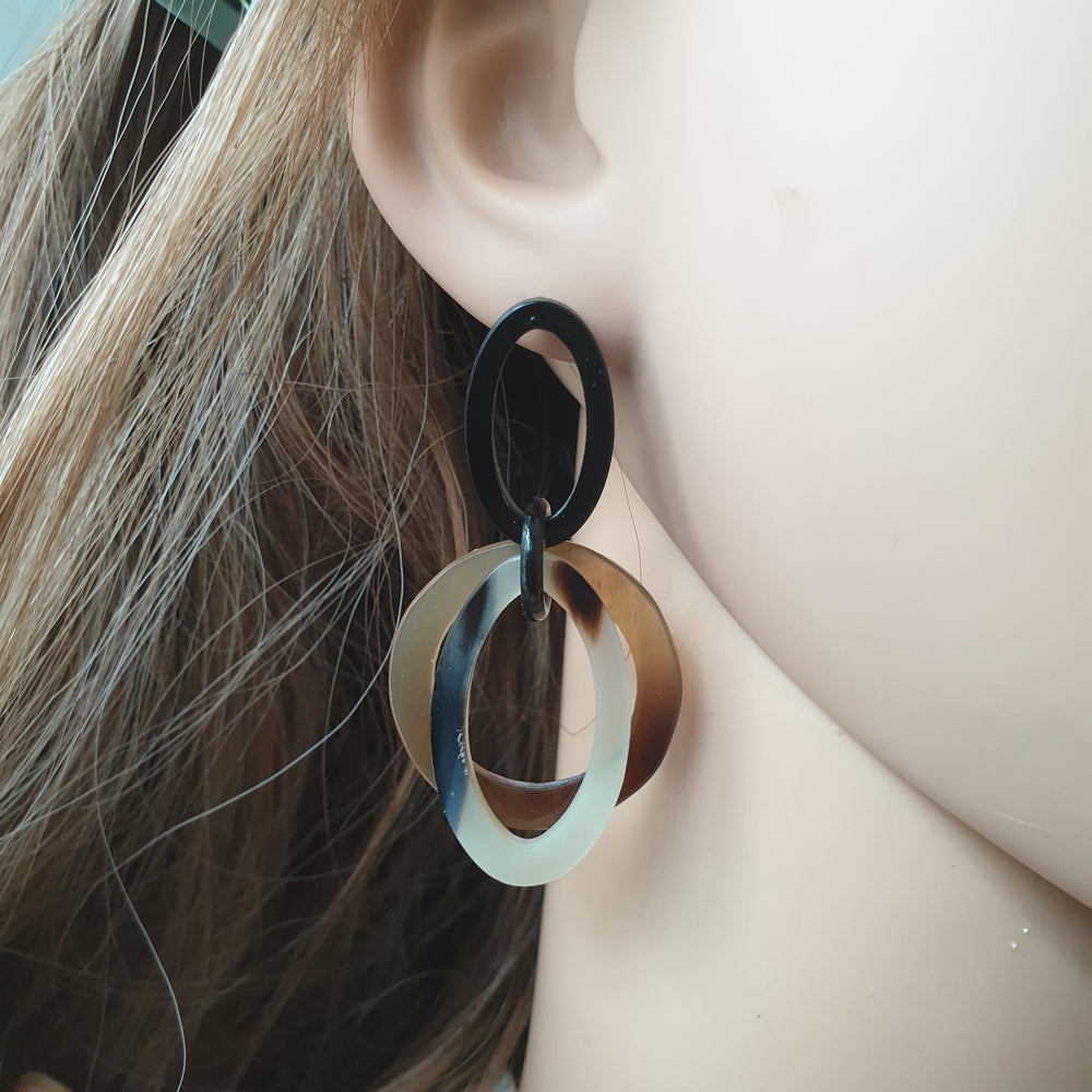 
                  
                    handmade double oval earrings feature brown and white in natural buffalo horn for Spring 2023 on a mennequin
                  
                