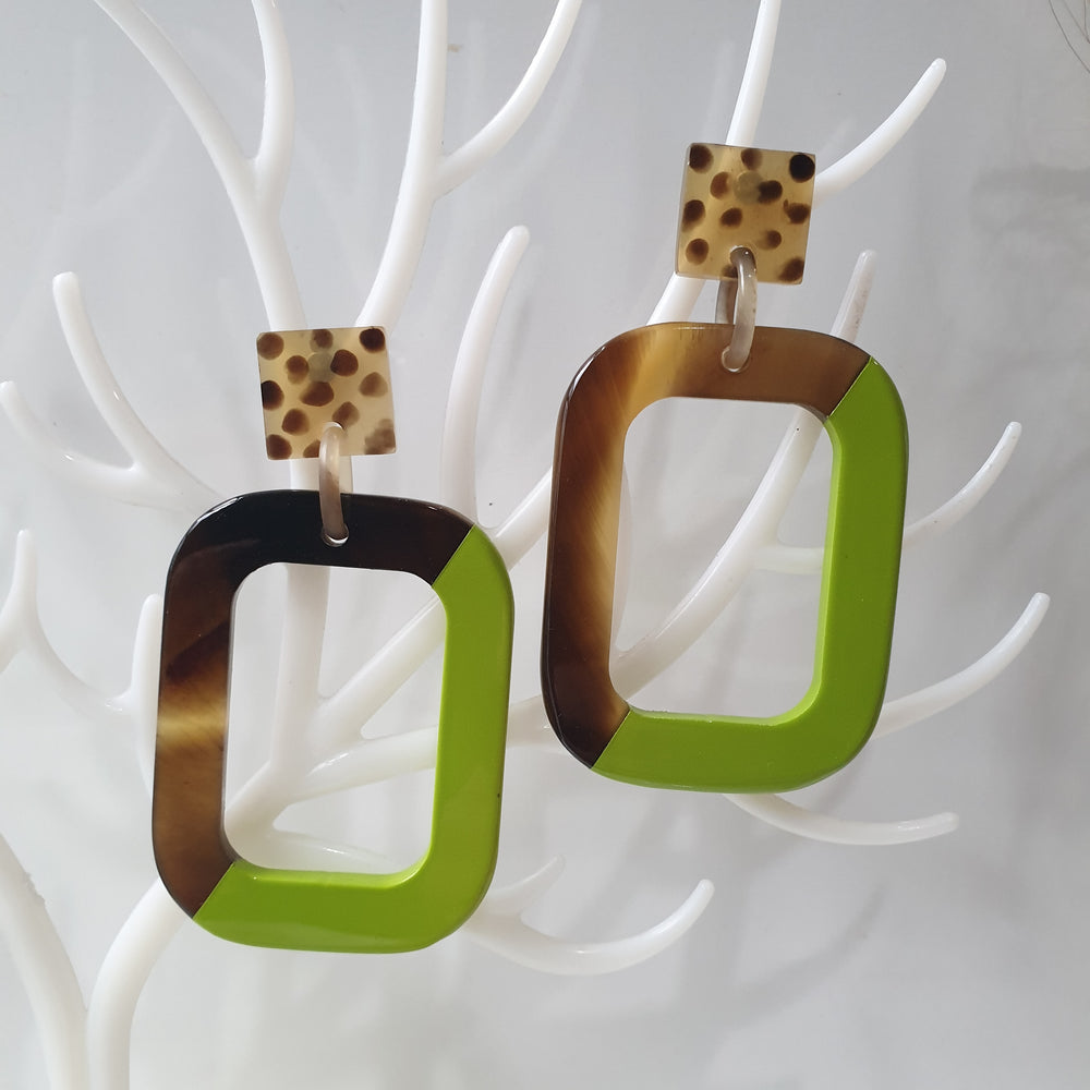 
                  
                    Handmade rectangle earrings feature leopard print and half dark and green in natural buffalo horn for Spring 2023
                  
                