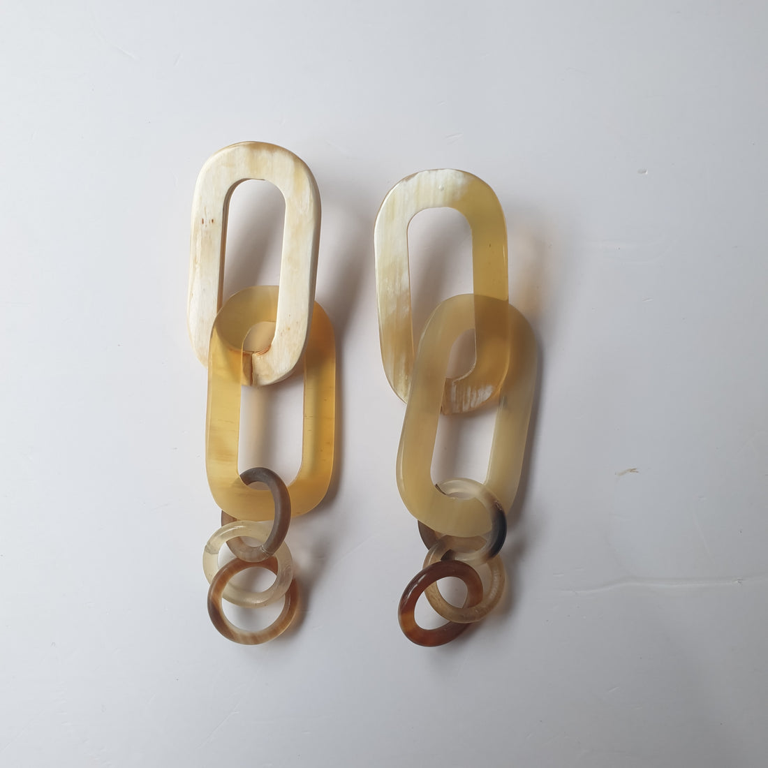 Handmade circle rectangle chain link earrings feature pale yellow in natural buffalo horn