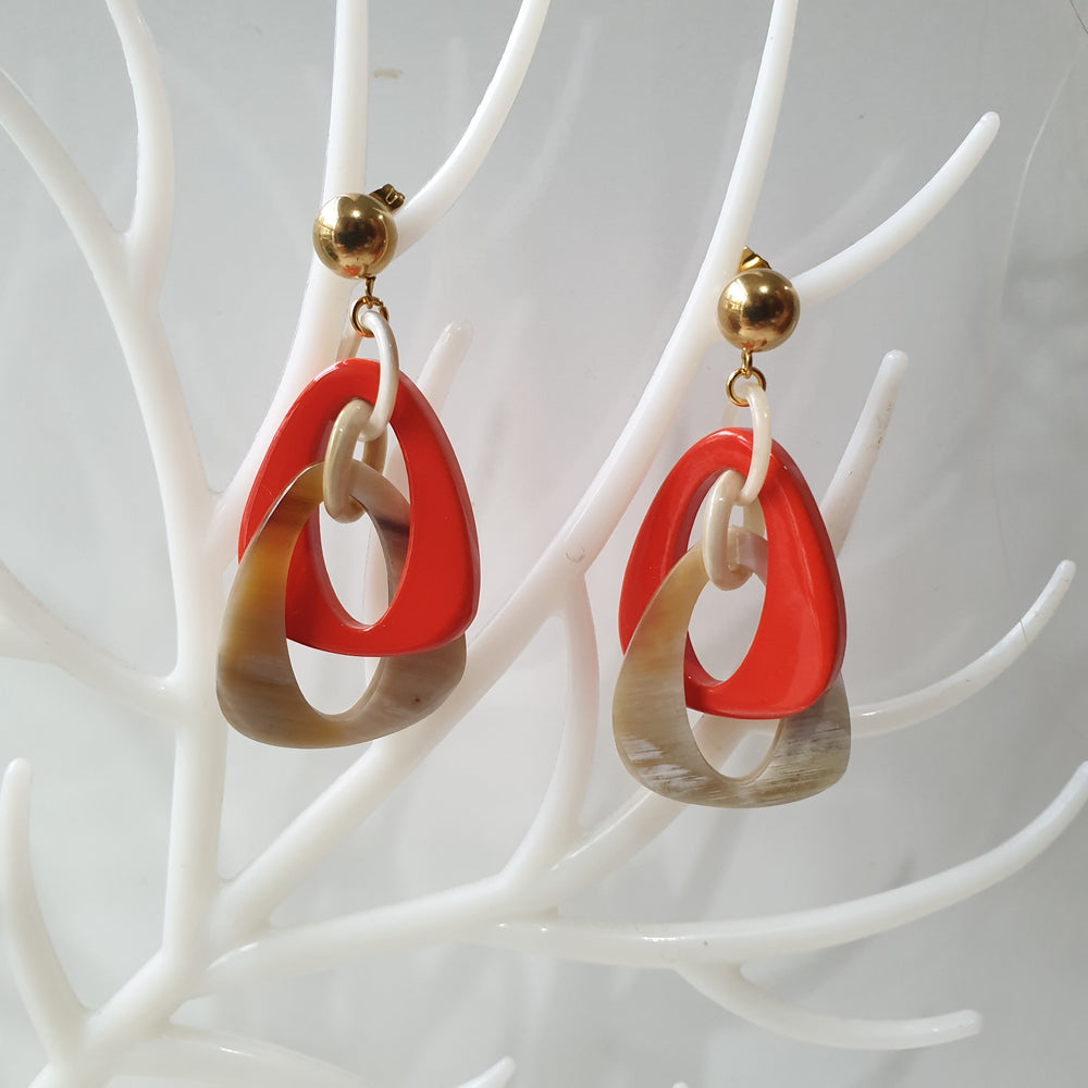 
                  
                    handmade double triangle earrings feature white and orange red in natural buffalo horn for Spring 2023
                  
                