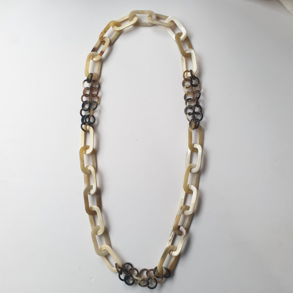 
                  
                    handmade chain link necklace features white rectangular and black circle in natural buffalo horn for Spring 2023 jewelry
                  
                