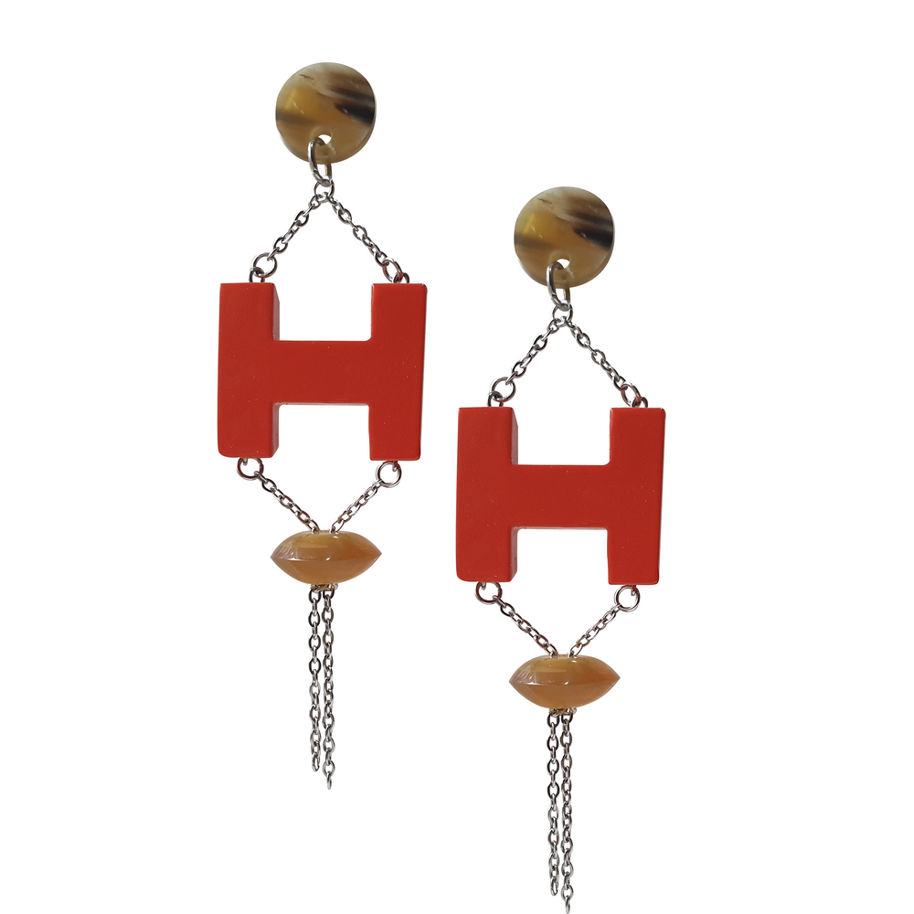 
                  
                    Handmade H-shaped earrings feature orange red in natural buffalo horn for Spring 2023
                  
                