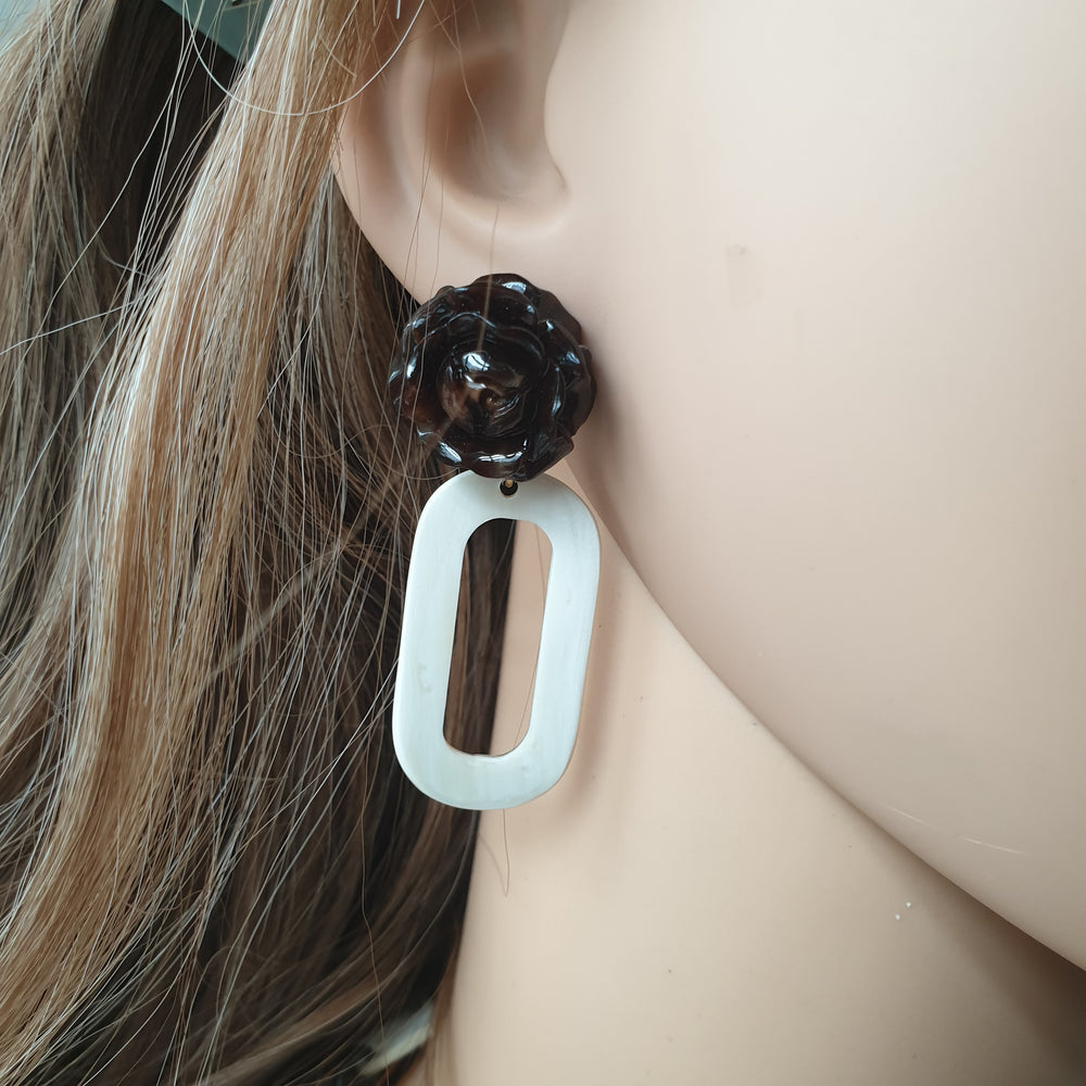 
                  
                    handmade earrings feature rose black and white rectangle in natural buffalo horn for Spring 2023 on a mannequin
                  
                