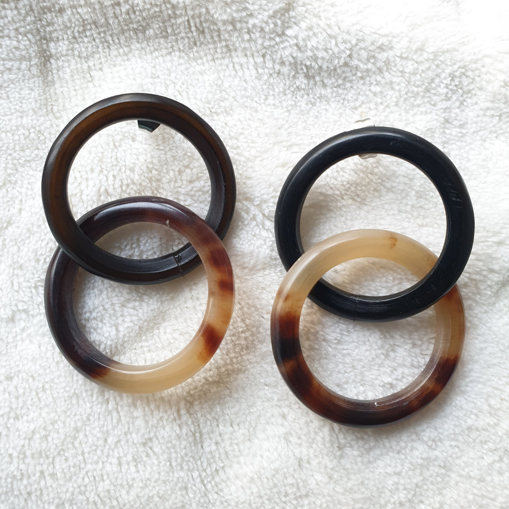 
                  
                    handmade earrings feature double black and brown circle in natural buffalo horn for Spring 2023
                  
                