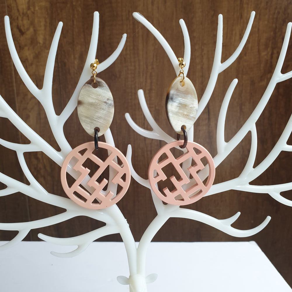 
                  
                    handmade circle post back earrings feature bright pink in natural buffalo horn for Spring 2023
                  
                