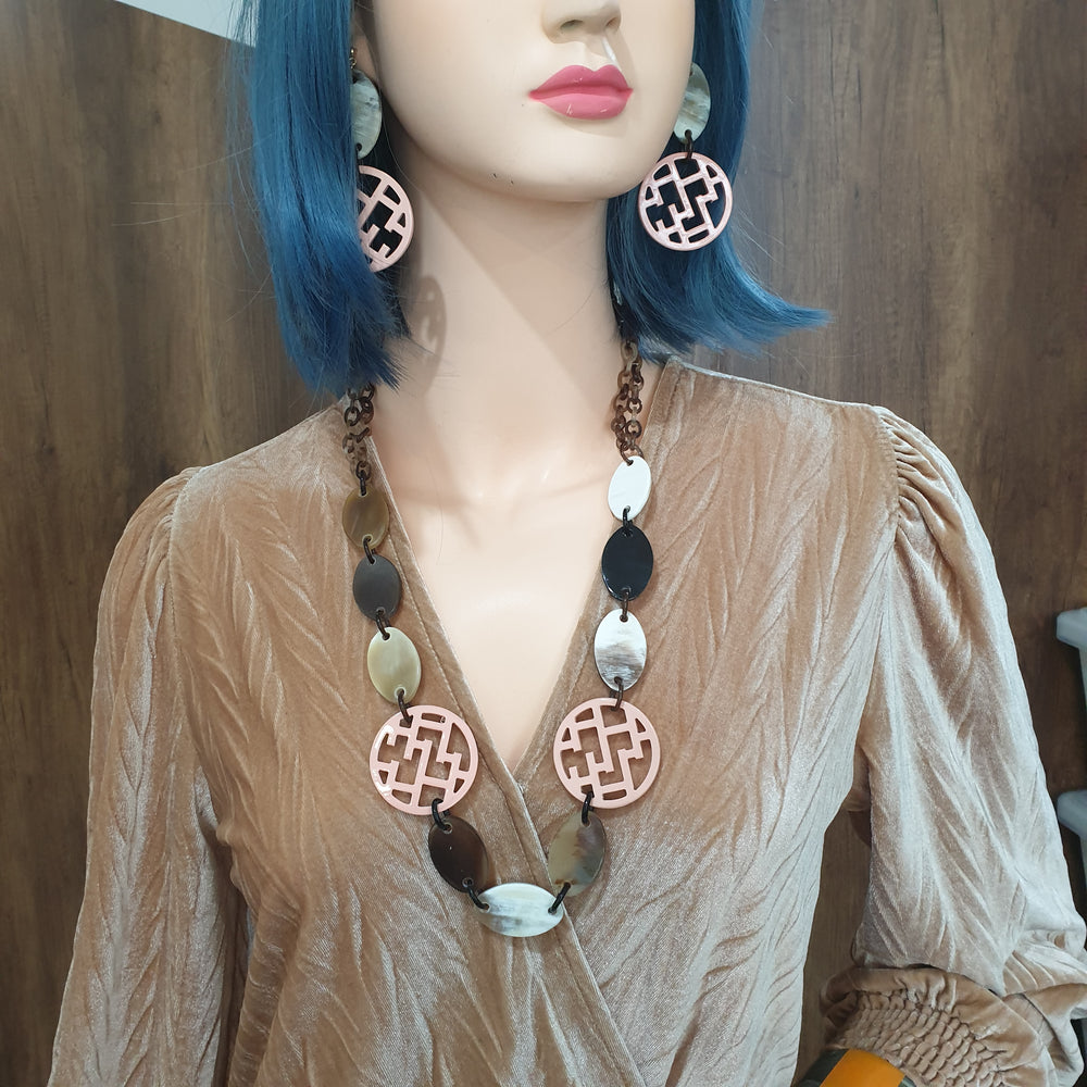 
                  
                    handmade circle post back earrings feature bright pink in natural buffalo horn for Spring 2023
                  
                