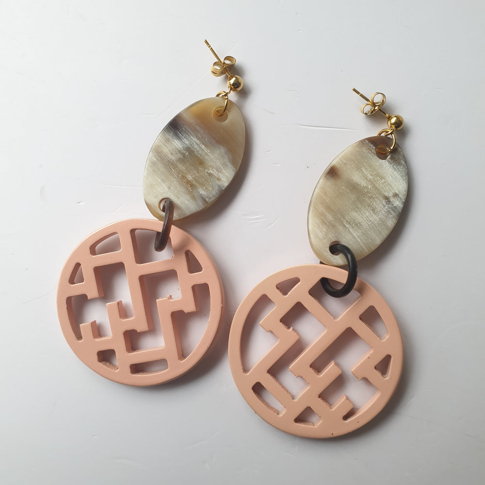 
                  
                    handmade circle post back earrings feature bright pink in natural buffalo horn for Spring 2023
                  
                