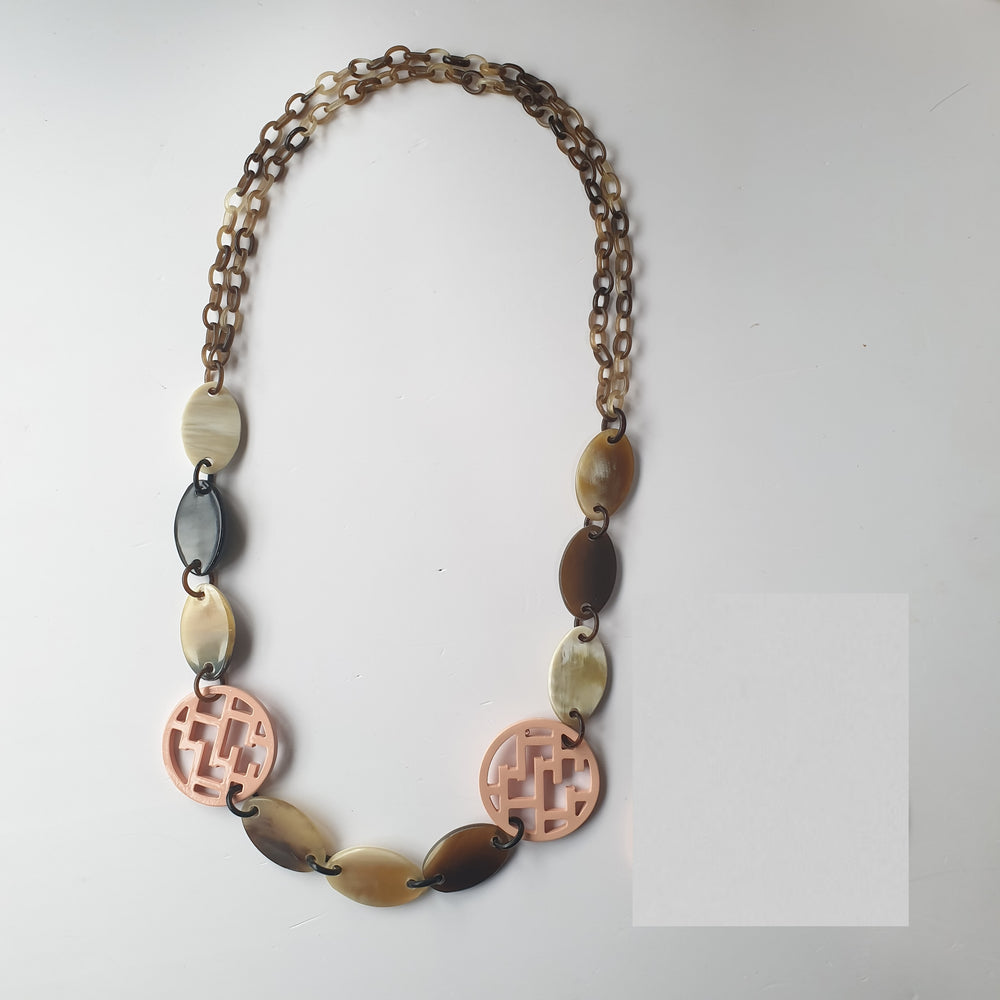 
                  
                    handmade chain link necklace feature bright pink in natural buffalo horn for Spring 2023
                  
                