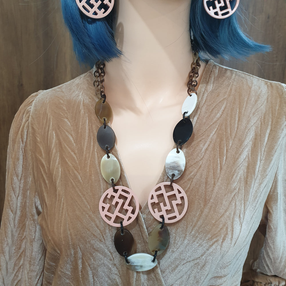 
                  
                    handmade chain link necklace feature bright pink in natural buffalo horn for Spring 2023
                  
                