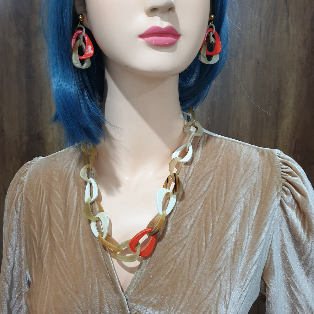 
                  
                    handmade chain link necklace features brown, red, and white in natural buffalo horn for Spring 2023
                  
                