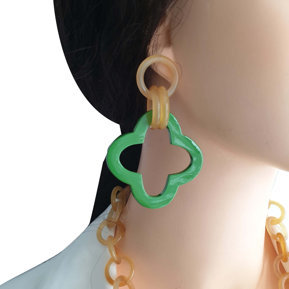 
                  
                    a model wears unique handmade green earrings 
                  
                