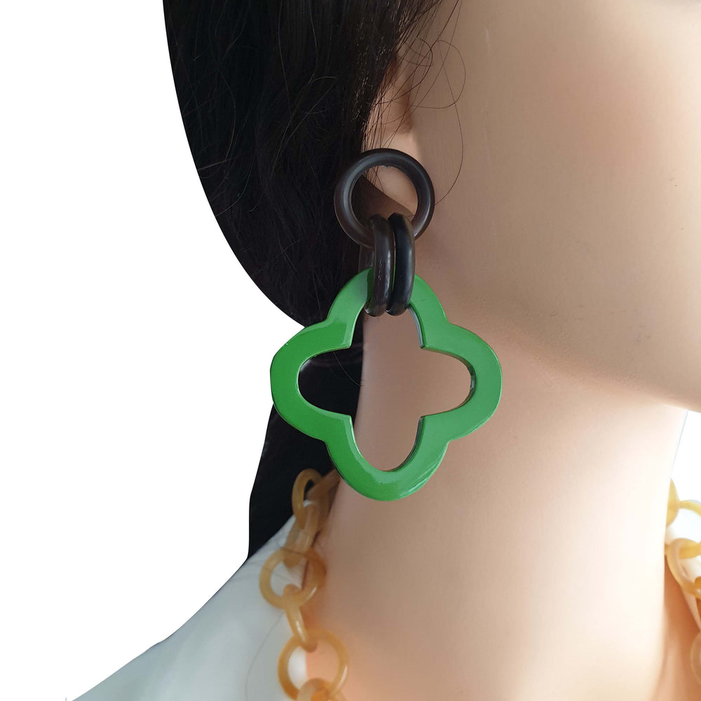 
                  
                    a model wears unique handmade green earrings 
                  
                