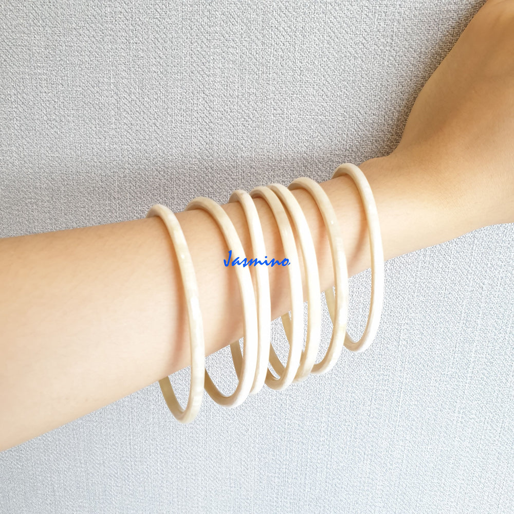 
                  
                    A set of Jasmino unique handmade Minimalist Vintage thin bangle bracelets feature white in natural buffalo horn for women
                  
                