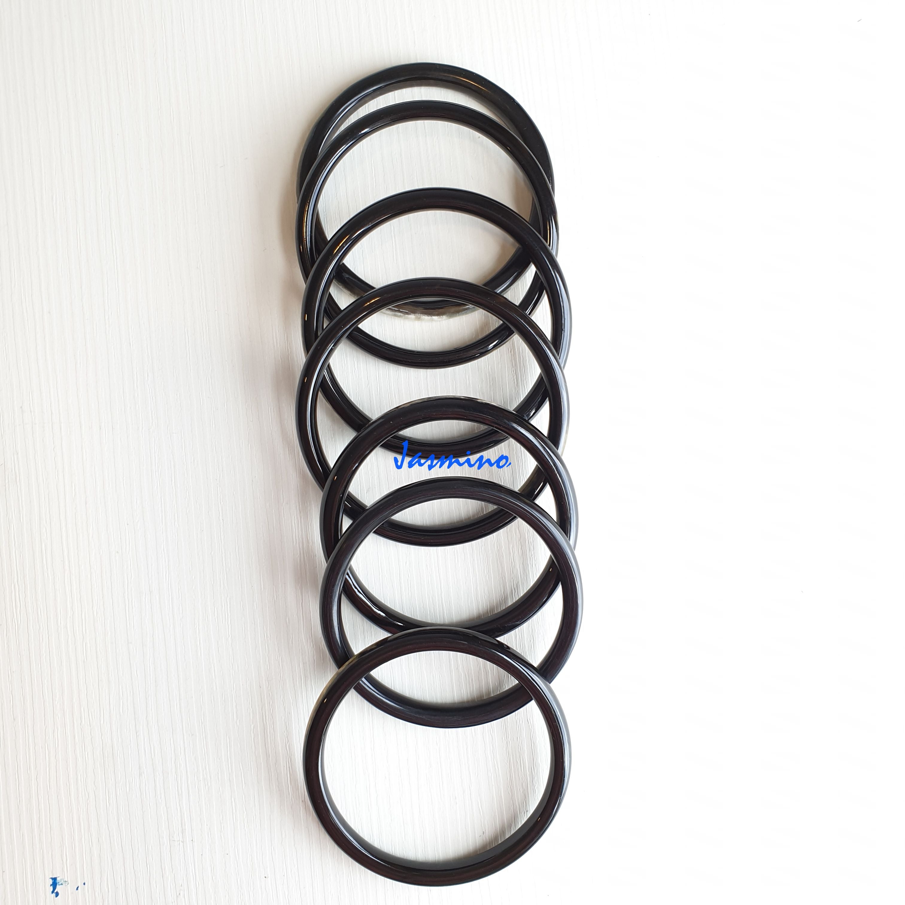 set of seven dark buffalo horn bracelets in natural light, an impressive gift for her