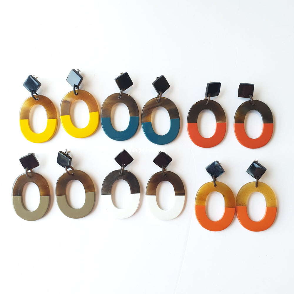 
                  
                    A set of handmade oval earrings is made by natural buffalo horn in the natural light
                  
                