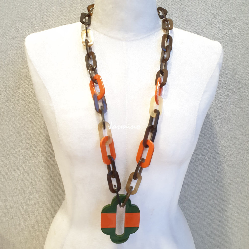 
                  
                    lacquer buffalo horn necklace with orange peel scarlet natural horn pendant in natural light
                  
                