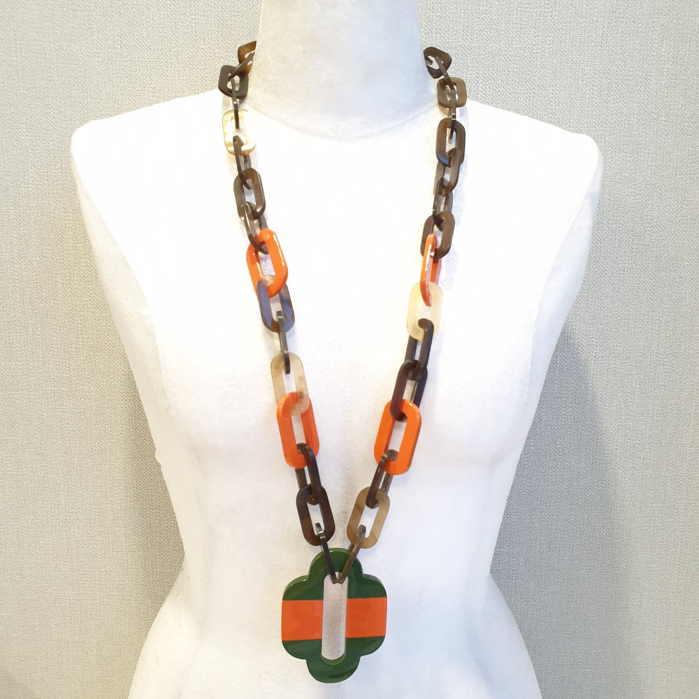 
                  
                    lacquer buffalo horn necklace with trendy orange green natural horn pendant in natural light
                  
                