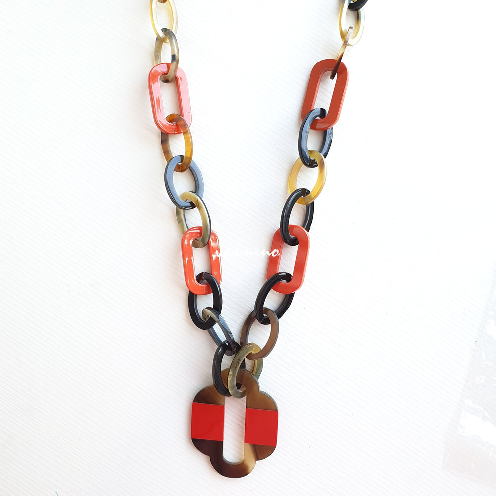 
                  
                    lacquer buffalo horn necklace with trendy flame scarlet natural horn pendant in natural light
                  
                