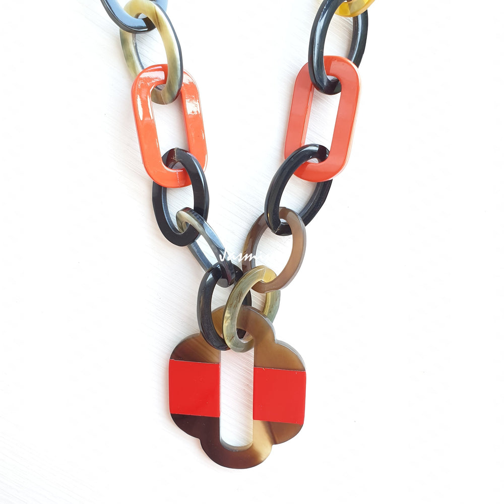 
                  
                    lacquer buffalo horn necklace with trendy orange red natural horn pendant in natural light
                  
                