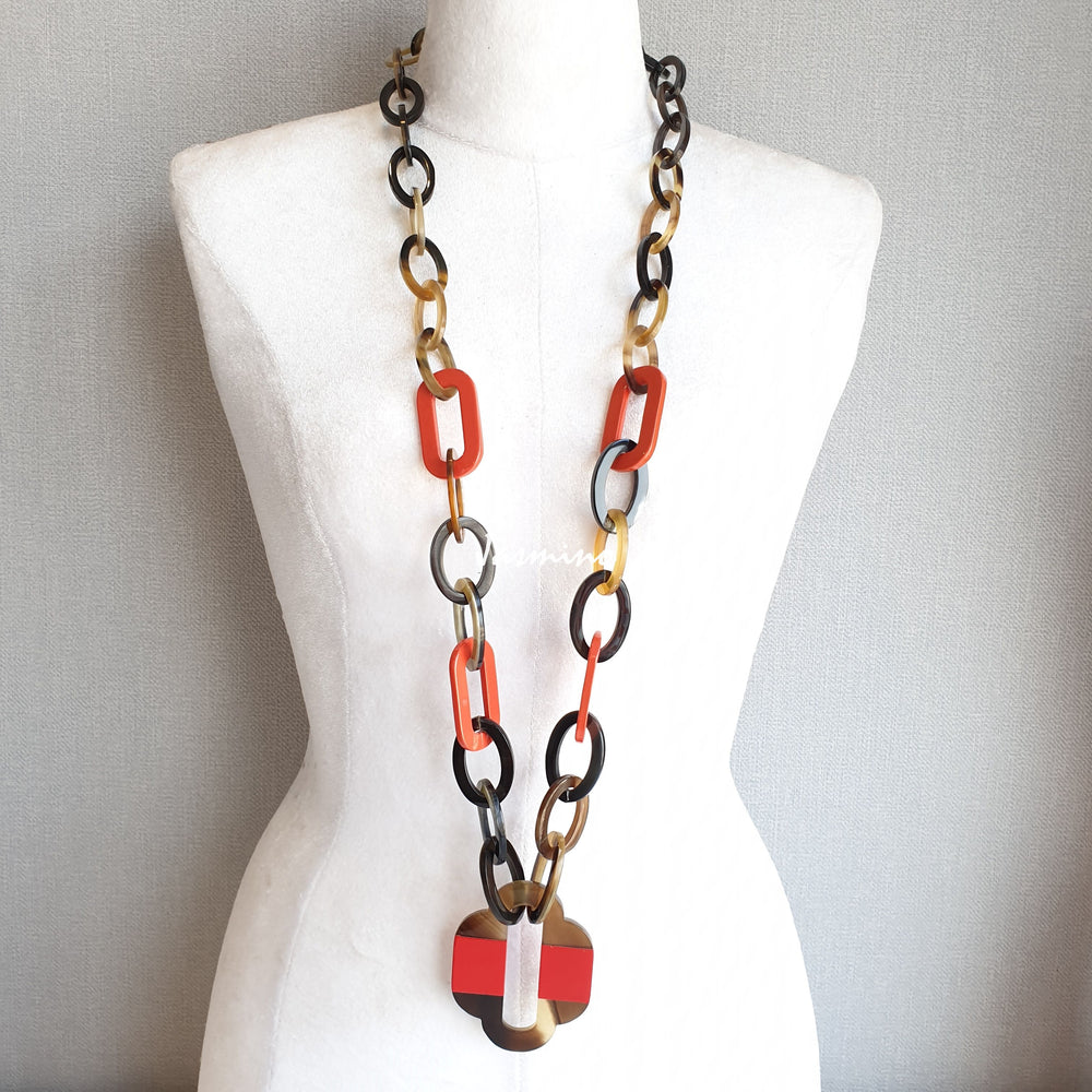 
                  
                    lacquer buffalo horn necklace with trendy flame scarlet natural horn pendant in natural light
                  
                