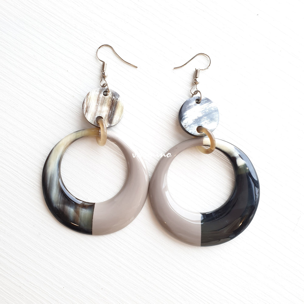 
                  
                    Handmade circular earrings are made of natural buffalo horn featured white and black color in the natural light
                  
                