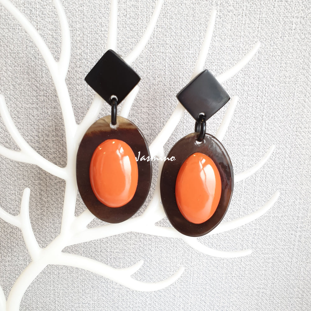 
                  
                    Jasmino unique handmade Bohemian mermaid beach oval drop earrings feature orange and brown made of natural buffalo horn
                  
                