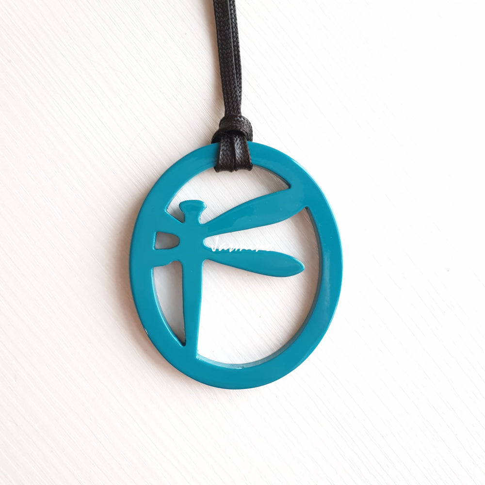 
                  
                    elliptical nobility pendant with dragonfly pattern inside on the light background, impressive gift for her
                  
                