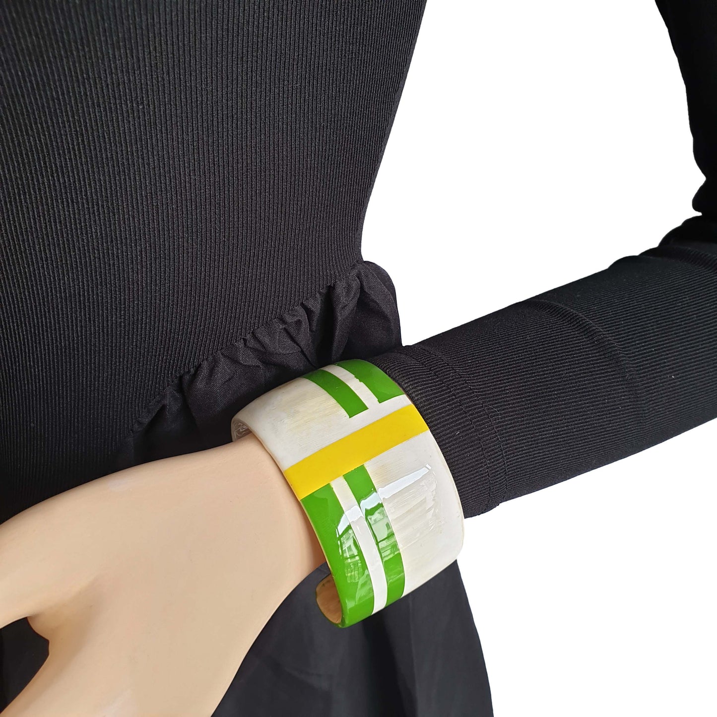 Bright horn jewelry cuff bracelet features white, green, and yellow on wrist