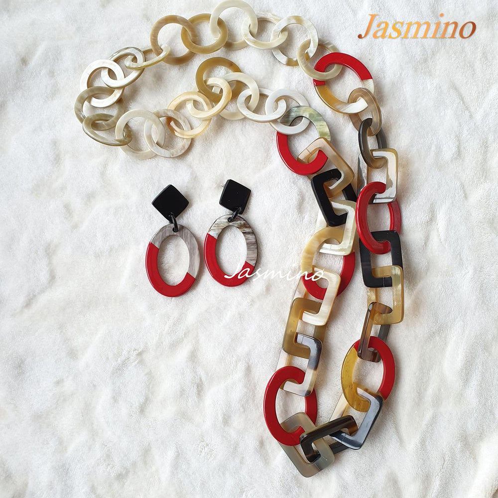 
                  
                    A set of the oval earrings and wide link chains feature red color in the natural light
                  
                