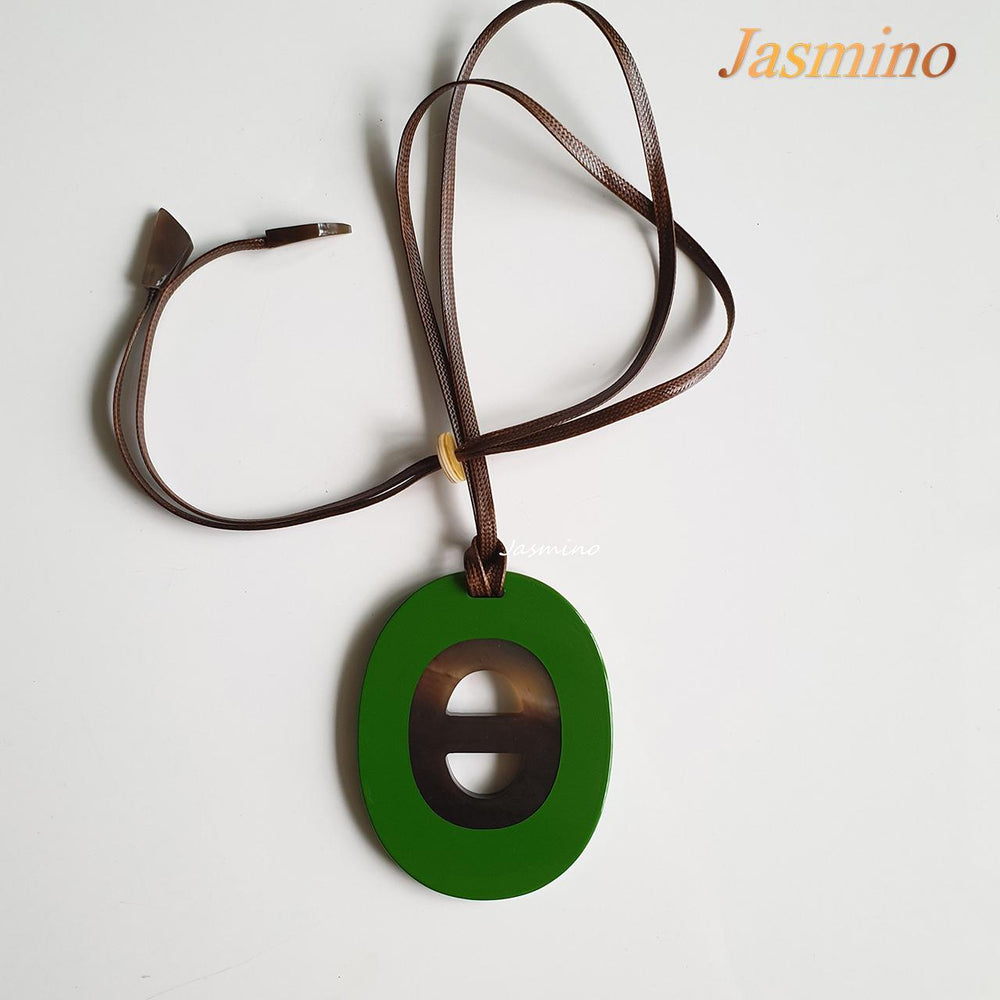 
                  
                    Jasmino unique handmade alphabet letter D pendant features green in natural buffalo horn
                  
                