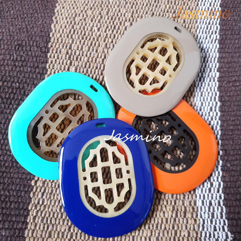 
                  
                    a collection of unique handmade Bohemian oval necklaces features bright colors in the natural light
                  
                