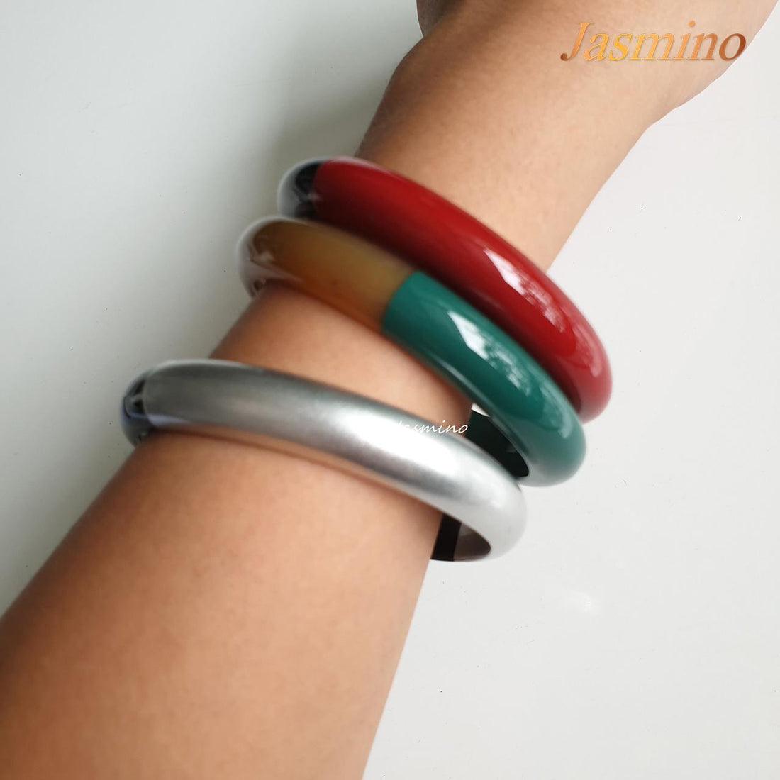A model is wearing bracelet is designed with half natural horn and half flame scarlet lacquer, unique Christmas gift for her