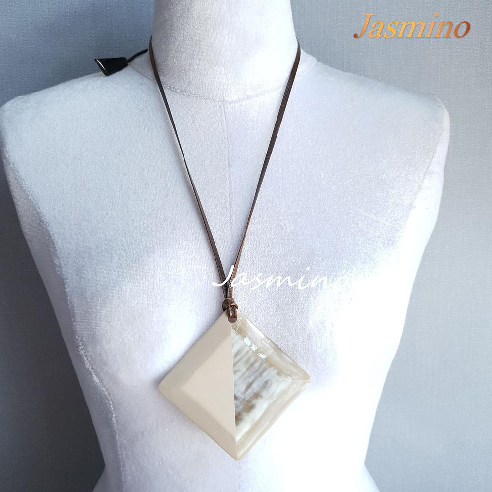 
                  
                    lozenge pendant with half natural horn and half painted beige on the light background, impressive gift for her
                  
                